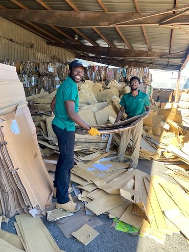 Two cardboard recycling specialist at a recycling center