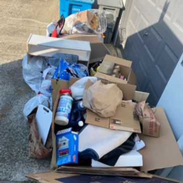Cardbords and trash in front of a garage door