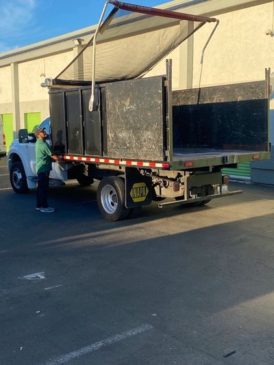 JYR Junk Removal crew member operating a dump truck for junk hauling in San Francisco