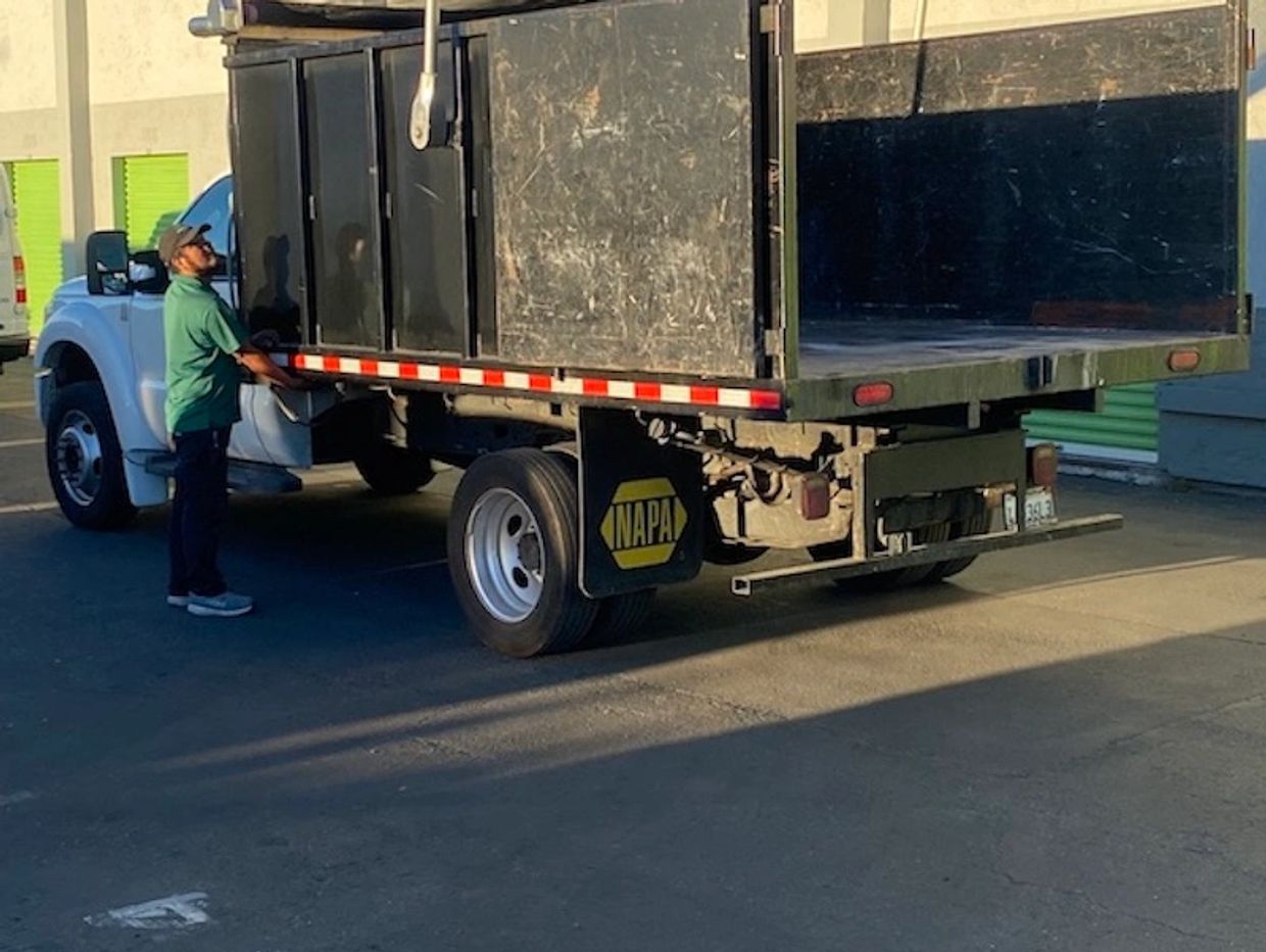 JYR Junk Removal crew member operating a dump truck for junk hauling in San Francisco