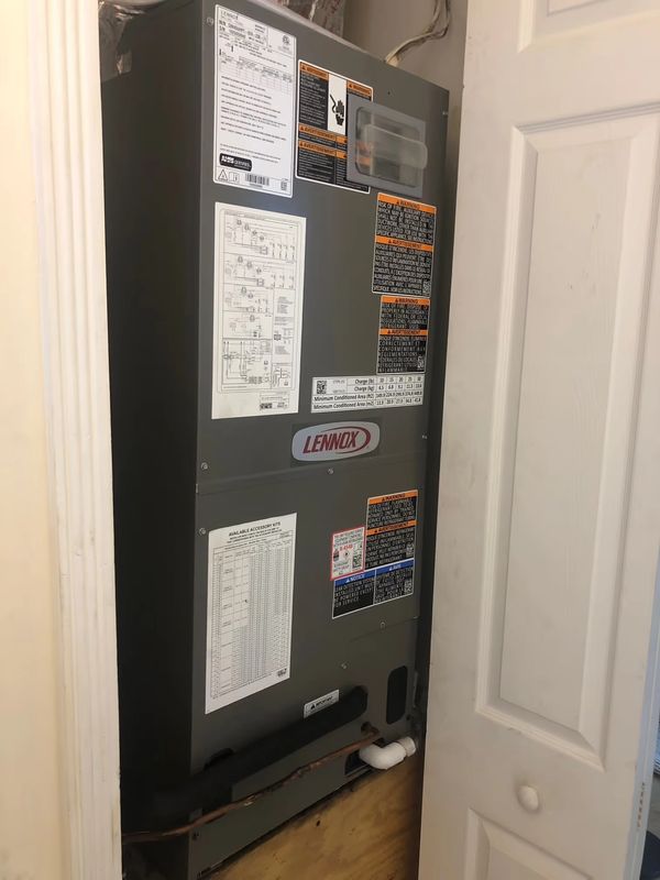 A Lennox HVAC unit installed in a narrow closet space.