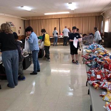 Community food distribution event indoors.