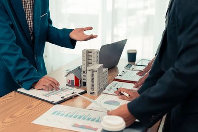 Professionals discussing real estate data.