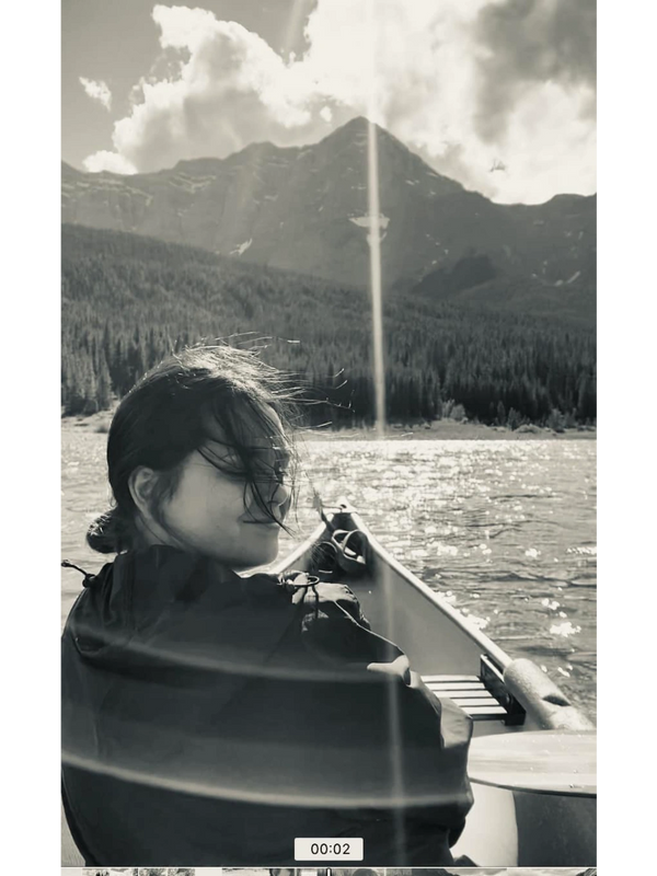 Birth doula on canoe in rocky mountains