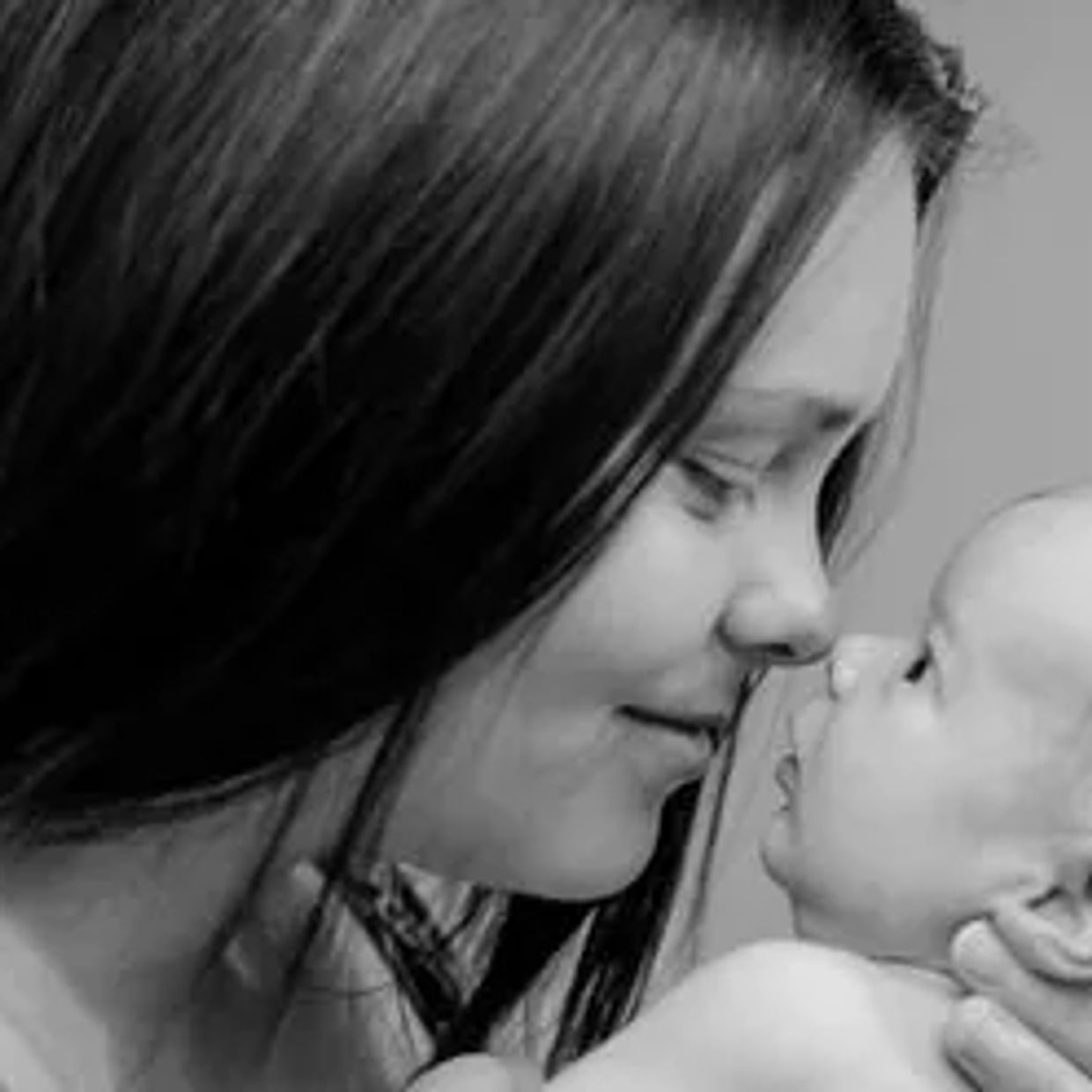 Mom and baby touching noses and smiling sweetly