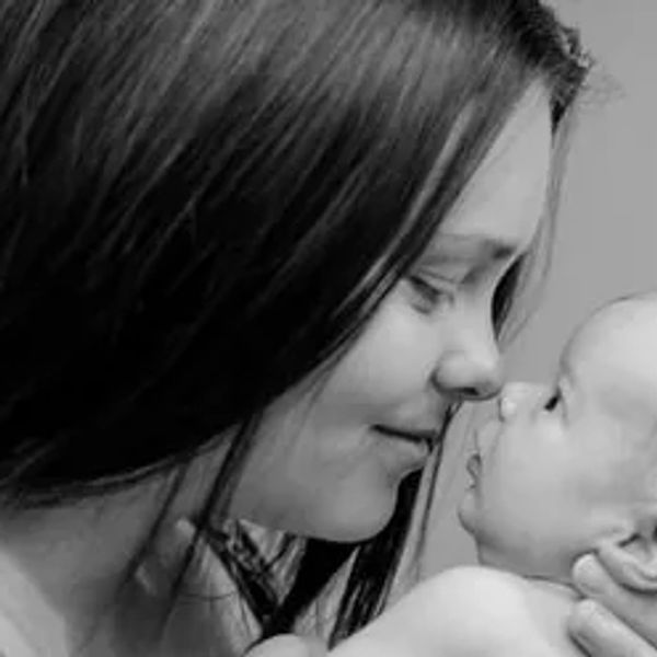 Mom and baby touching noses and smiling sweetly