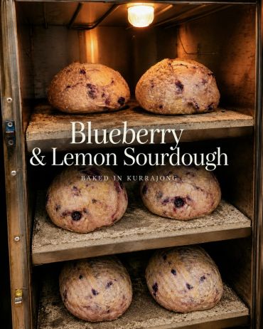 Blueberry and lemon sourdough loaves baking on shelves.