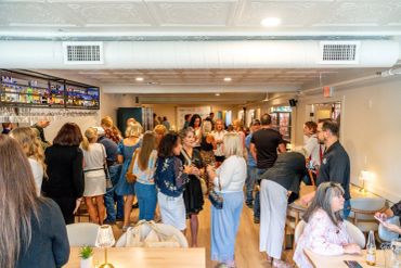 People socializing in a lively indoor gathering.