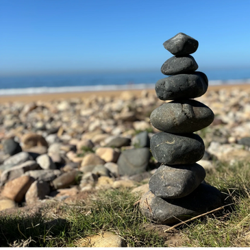 Stacked stones symbolising trust connection and safety in relational psychotherapy and counselling