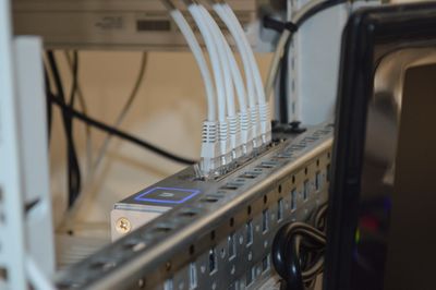 Six cables plugged into a network switch.
