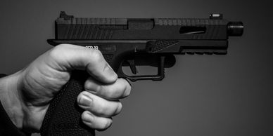 A handgun being held in a person's hand.