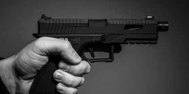 A handgun being held in a person's hand.