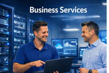 Two men discussing business services with a laptop in a server room.