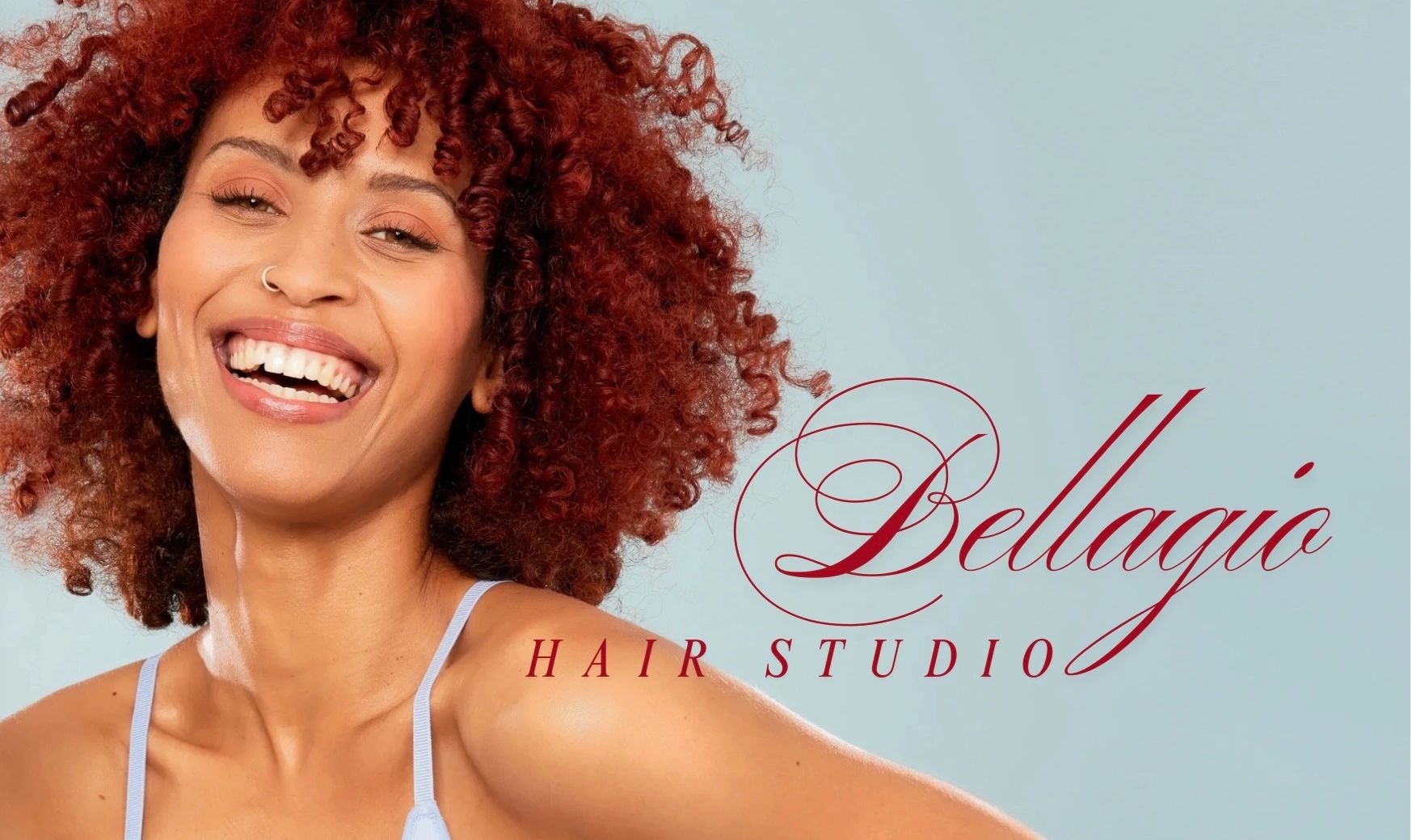 Smiling woman with curly red hair next to Bellagio Hair Studio logo.
