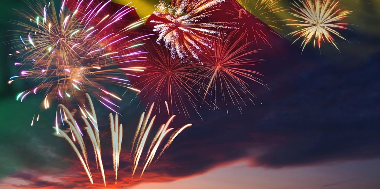 Holiday night sky with fireworks and flag of Cameroon for Independence day