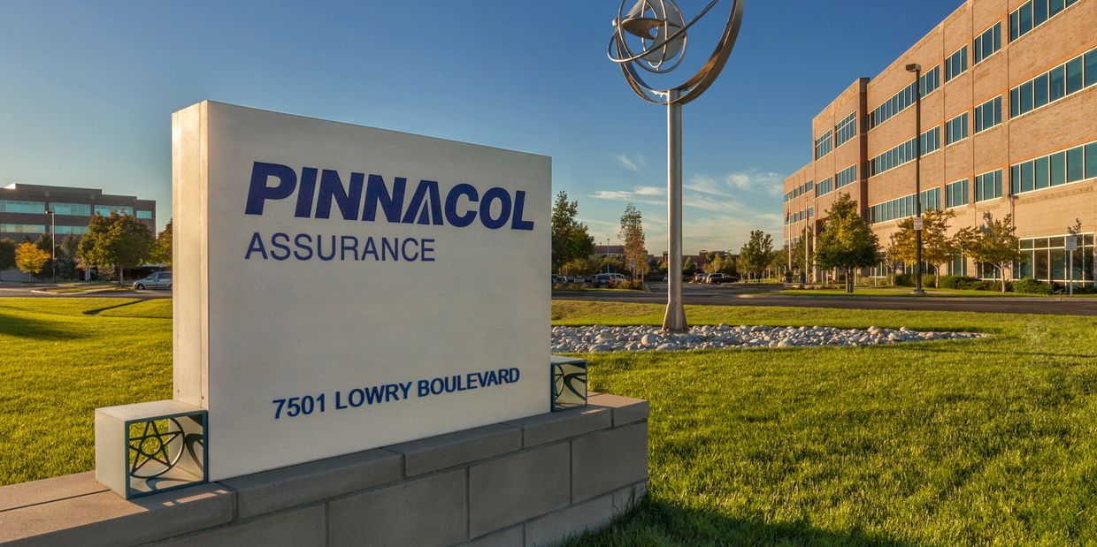 Pinnacol Assurance office sign at 7501 Lowry Boulevard with surrounding buildings.