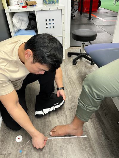 chiropractor measuring foot for custom orthotics