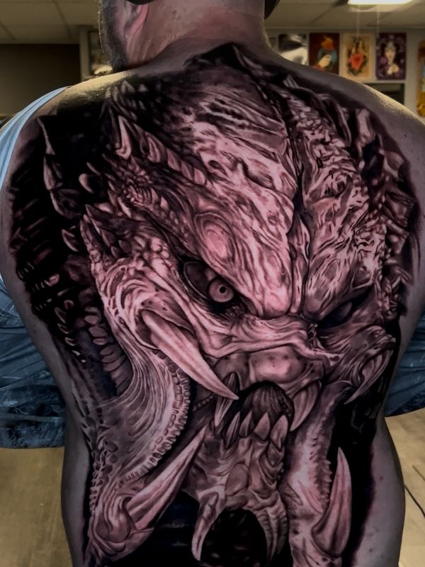 Intricate Predator tattoo covering a man's entire back.