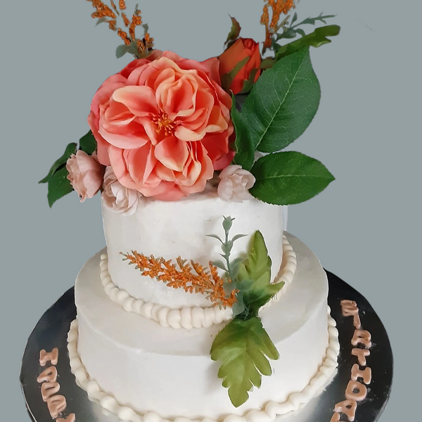2 Tier vanilla cake with vanilla buttercream with floral cake topper.