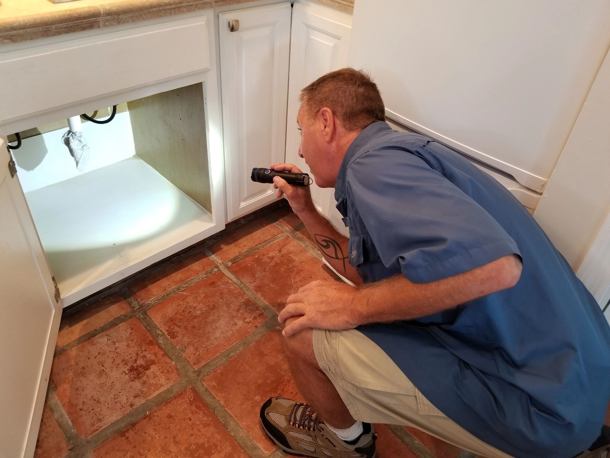Island Home Inspectors of North Florida, LLC - looking under the sink image. 