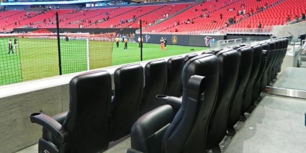 Luxury black leather seats in a stadium near the field.