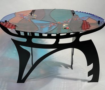 Title: Iceland Blues
Dimensions: 20″ H, 30″ W, 19″ D
Fused glass and steel table