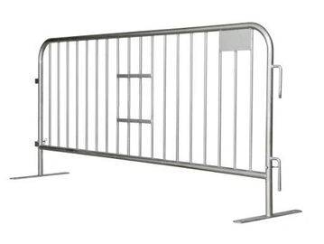 A metal crowd control barrier with vertical bars and support feet.