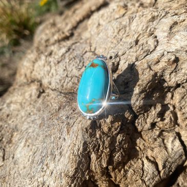 turquoise ring with hand engraving on underside made of sterling silver.