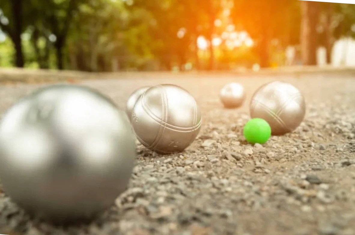 Petanque boules and cochonnet on pétanque terrain in the park.