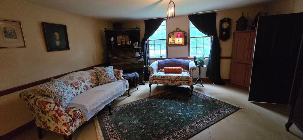 Music room of inn where guests can listen to a victrola or play the pedal organ