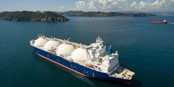 Large LNG tanker sailing near islands.