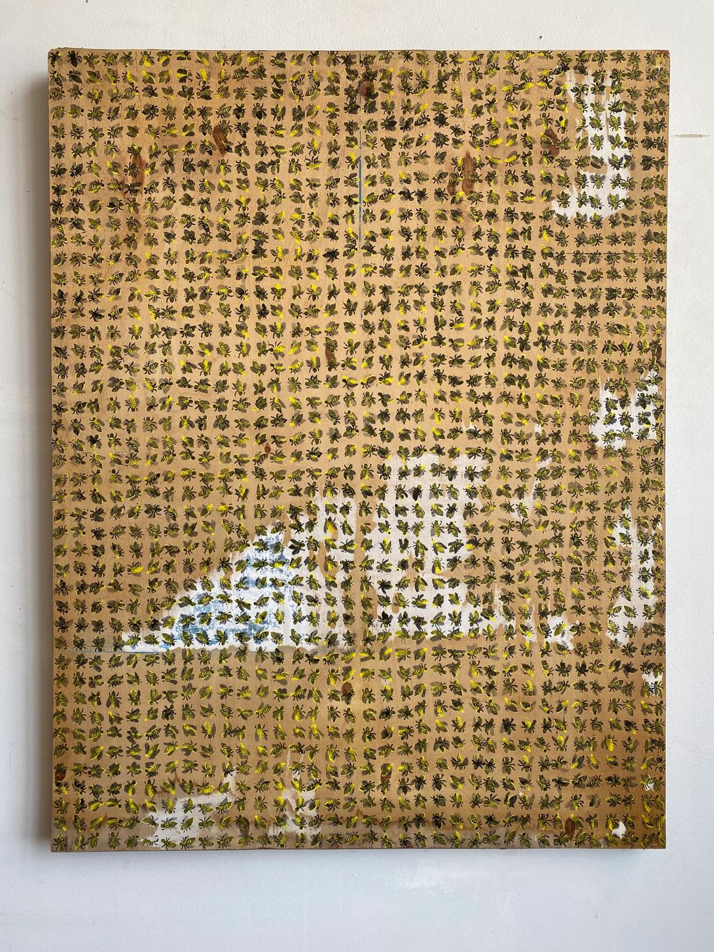 A grid of small painted ants on a wooden surface with a white reflective glare.