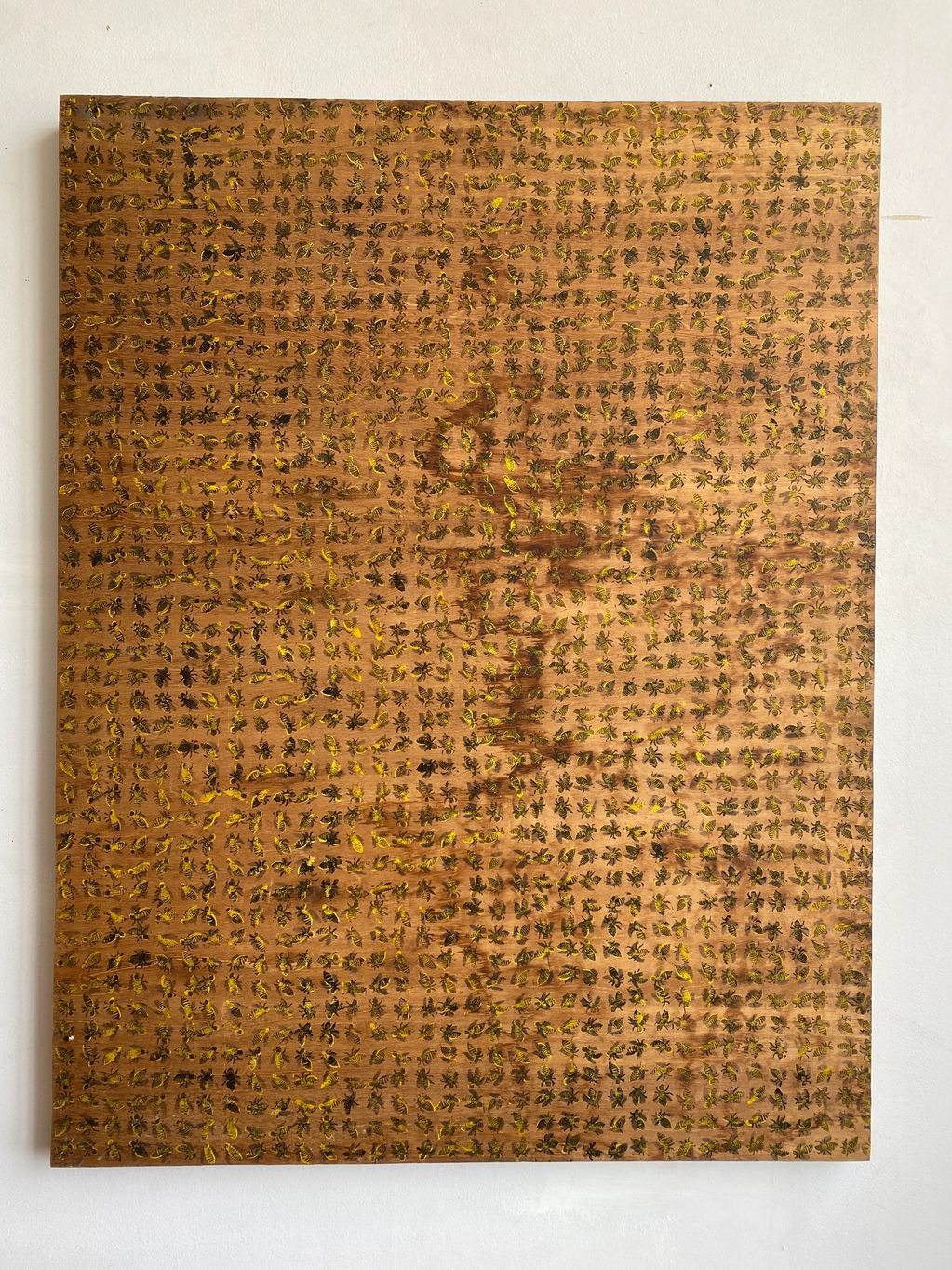 Wooden board with intricate patterns of black and yellow ants.