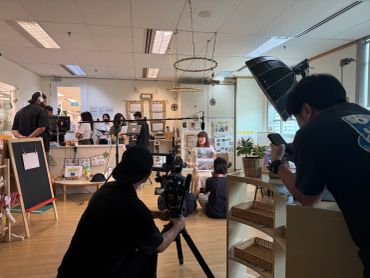 A group filming a video in a cozy office setting.