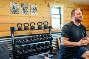 a man in black outfit exercising at R7 Sports Performance