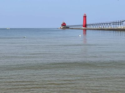 lake michigan water with pier with two red light houses