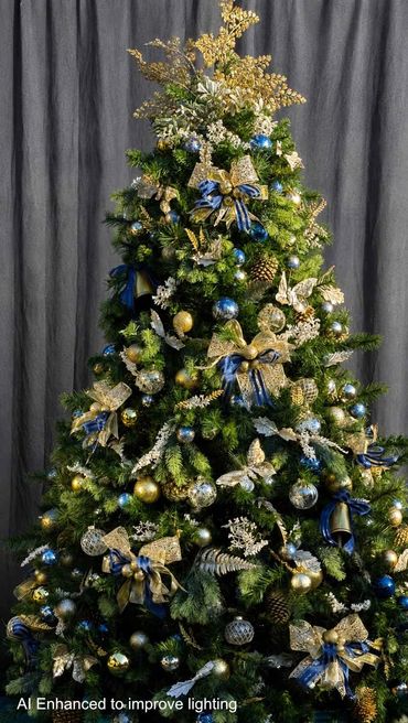 Blue and gold bells on Christmas tree with handmade bows and butterflies.