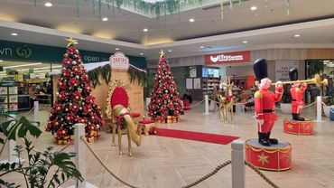 Traditional look Santa grotto featuring red and gold thumbing with fun details at Coast Plaza 2025.