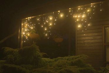 Warm white icicle lights at night - classic look.