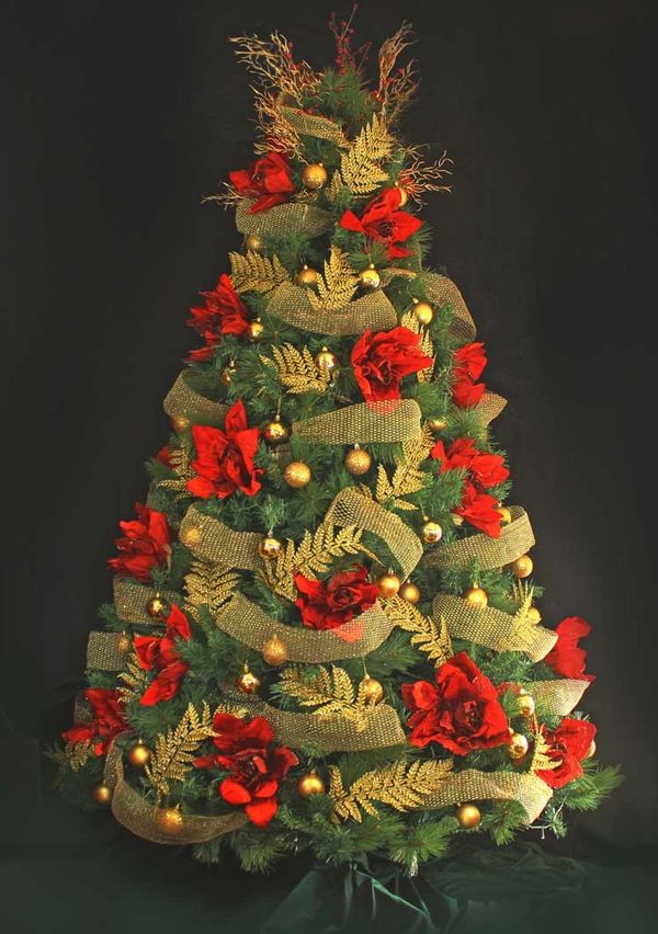 Large red roses, gold ferns, and mesh gold ribbon on fully decorated 8 foot Christmas tree.