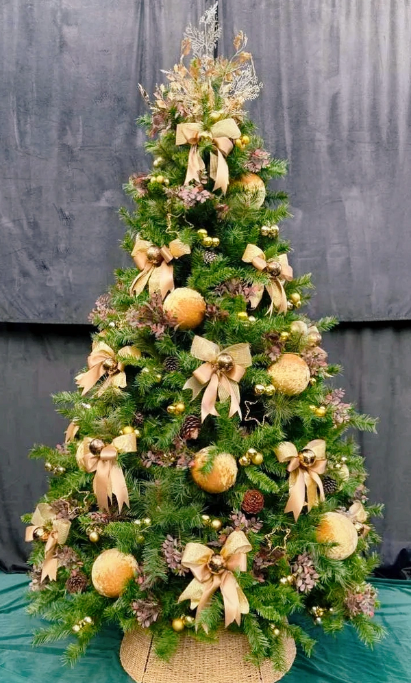 Luxury hotel style Christmas tree decorations on fully decorated gold and brown themed tree.