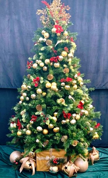 Gold bauble spiral tree with red Christmas flowers and luxury Christmas present bye with bells.