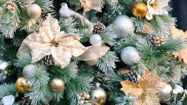 White and gold Christmas tree fully decorated.