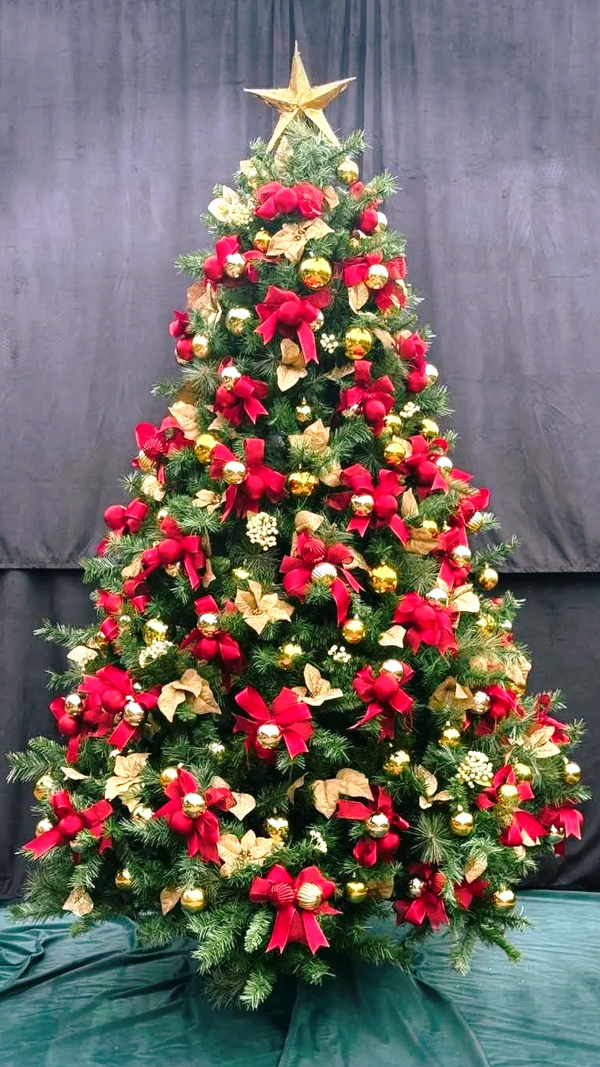 Fancy red Christmas bows, baubles and white berries on 7 foot Christmas tree design.