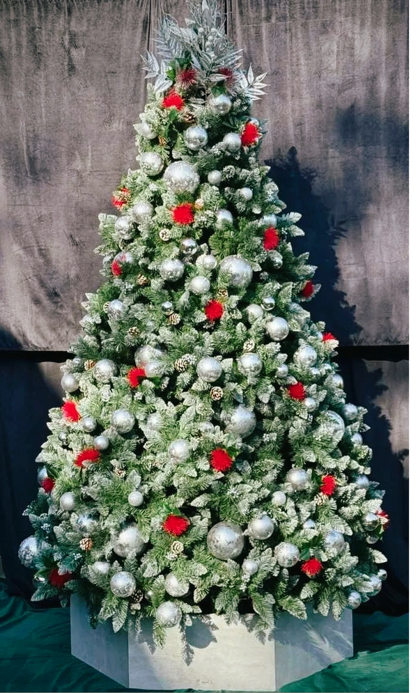 Professionally decorated silver flocked Christmas tree featuring Pohutakawa flowers and baubles.