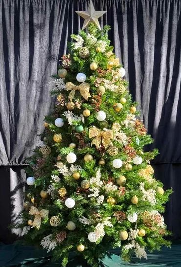 Natural coloured and gold Christmas tree decorations on 7 foot artificial pine tree with star.