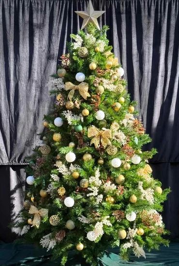 Natural coloured and gold Christmas tree decorations on 7 foot artificial pine tree with star.