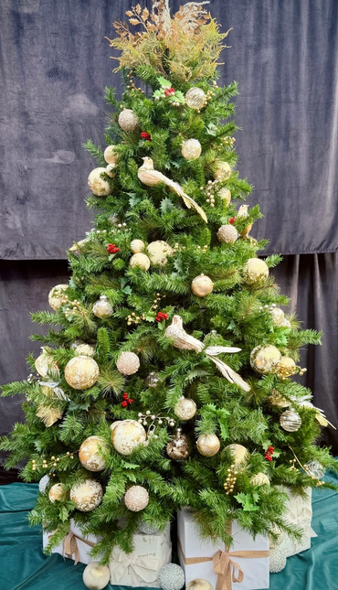 Professionally decorated dove Christmas tree with luxury present stack at base.
