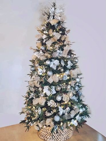 Champaign shimmer Christmas tree with fancy mesh ribbon, berries, snowflakes and poinsettia.