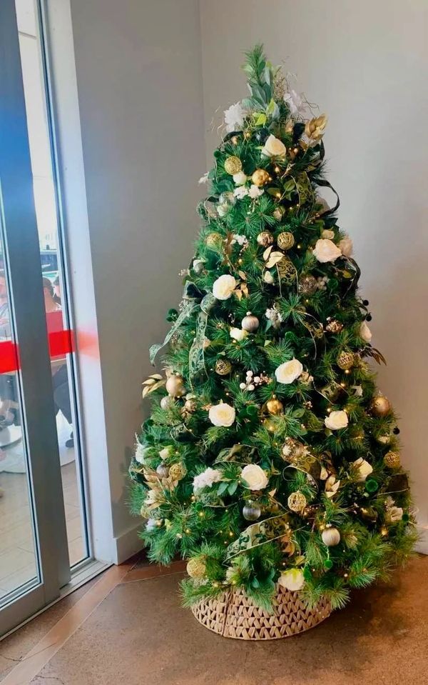 White and green luxury 7 foot Christmas tree at end of year party in restaurant.